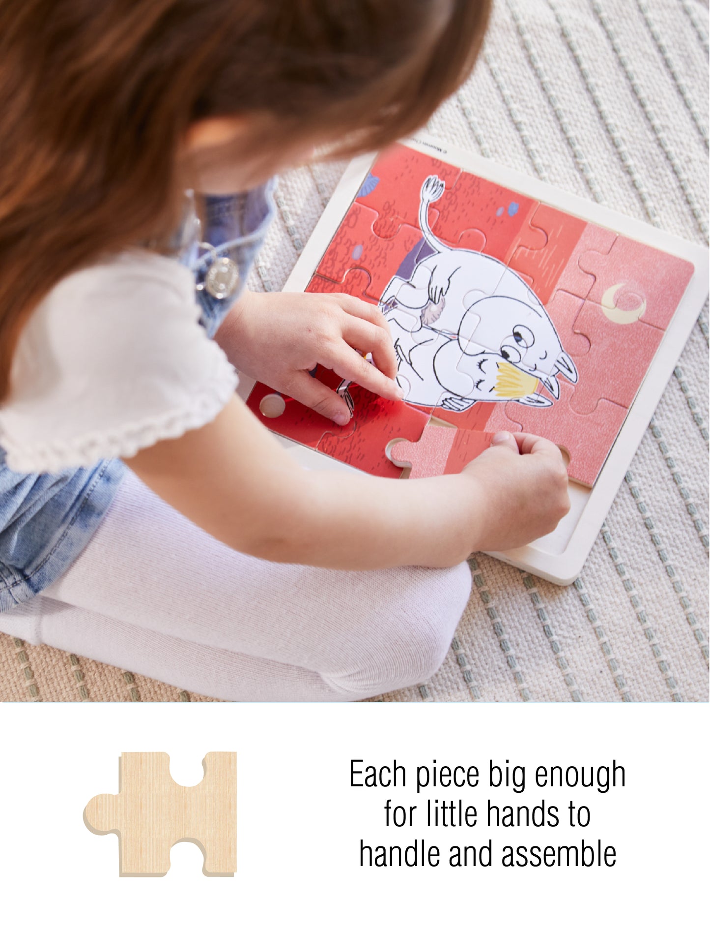 Child assembling a Moomin wooden puzzle with large pieces, designed for small hands. Text on image: 'Each piece big enough for little hands to handle and assemble'.