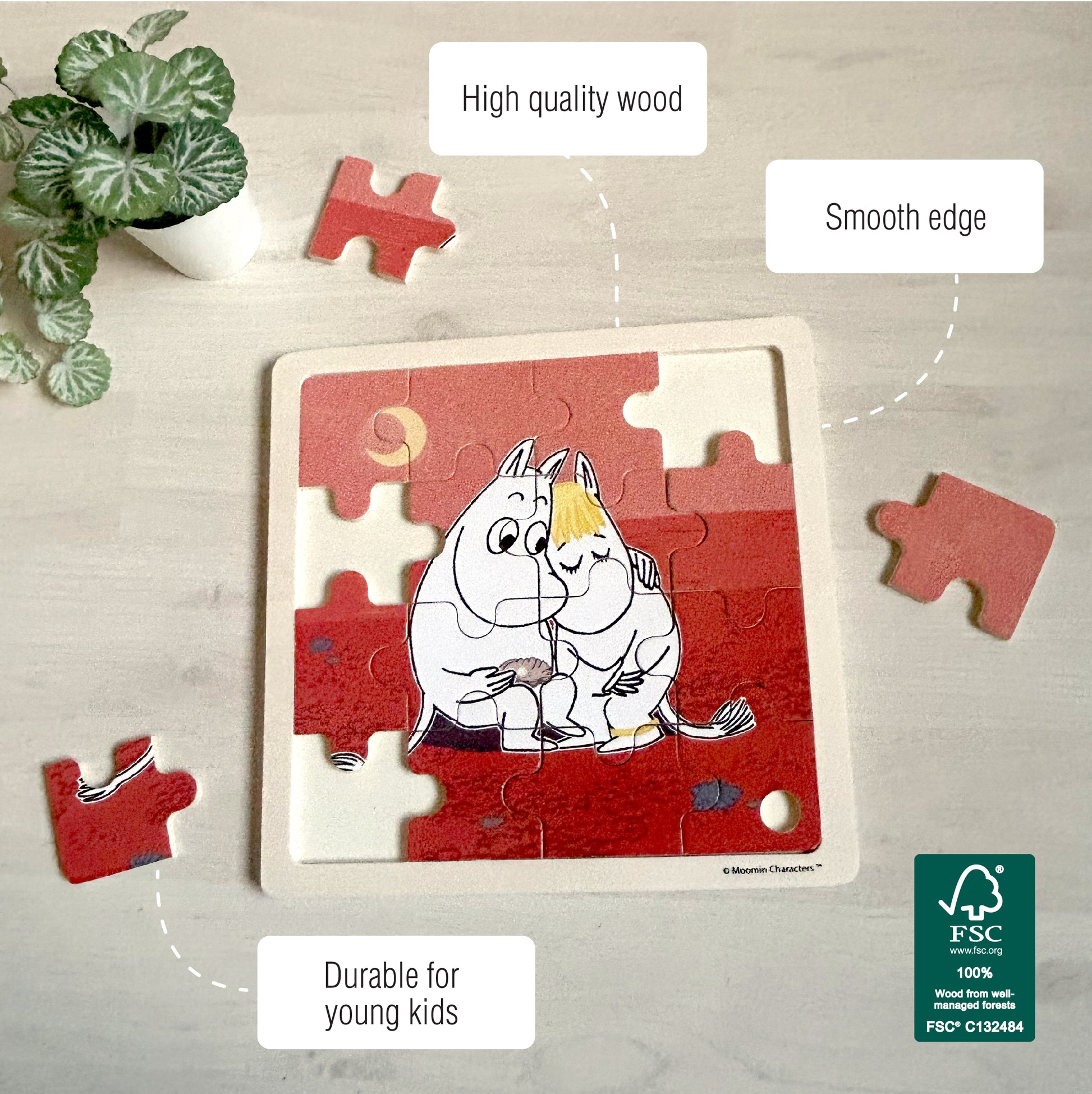 Partially assembled Moomin wooden puzzle featuring Moomintroll and Snorkmaiden hugging. Loose puzzle pieces are scattered around. Text on the image highlights 'High quality wood', 'Smooth edge', and 'Durable for young kids'. FSC certification logo is visible in the corner.