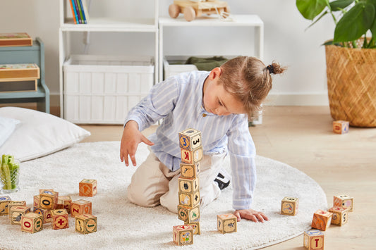 boy playing with moomin 32 wooden blocks with alphabet and numbers