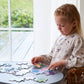 Girl playing with Peppa Pig family deco puzzle