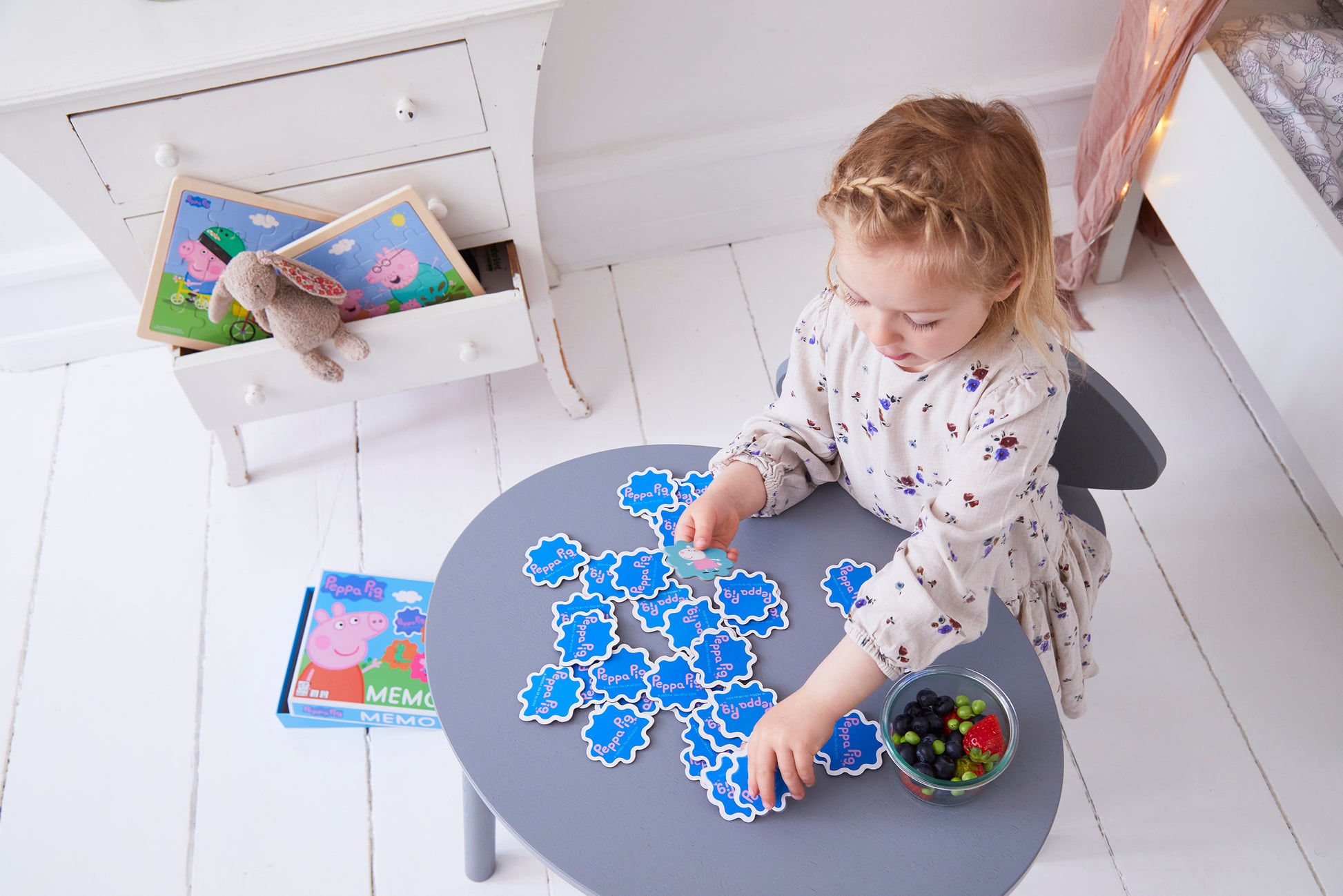 girl playing with peppa pig memory game 